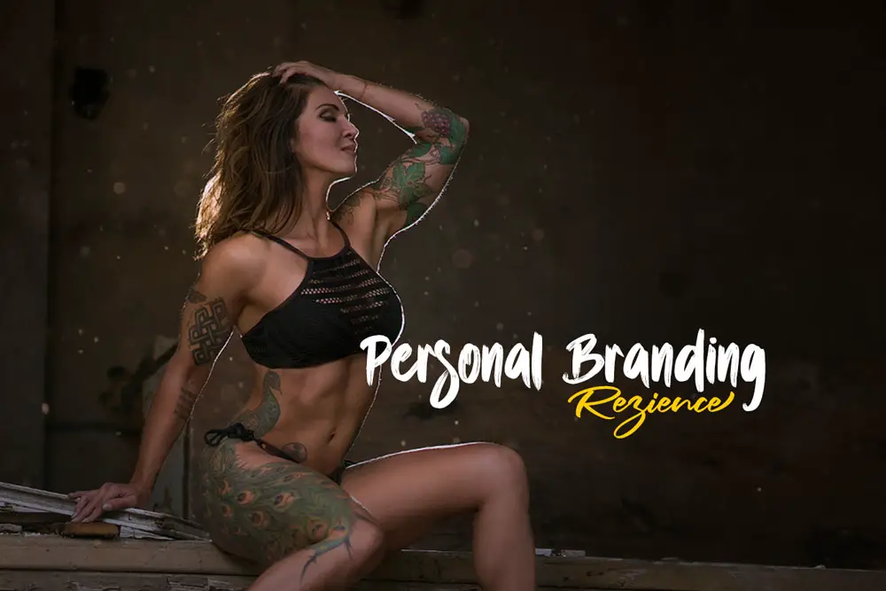 Confident tattooed woman in fitness attire posing for a personal branding photoshoot.