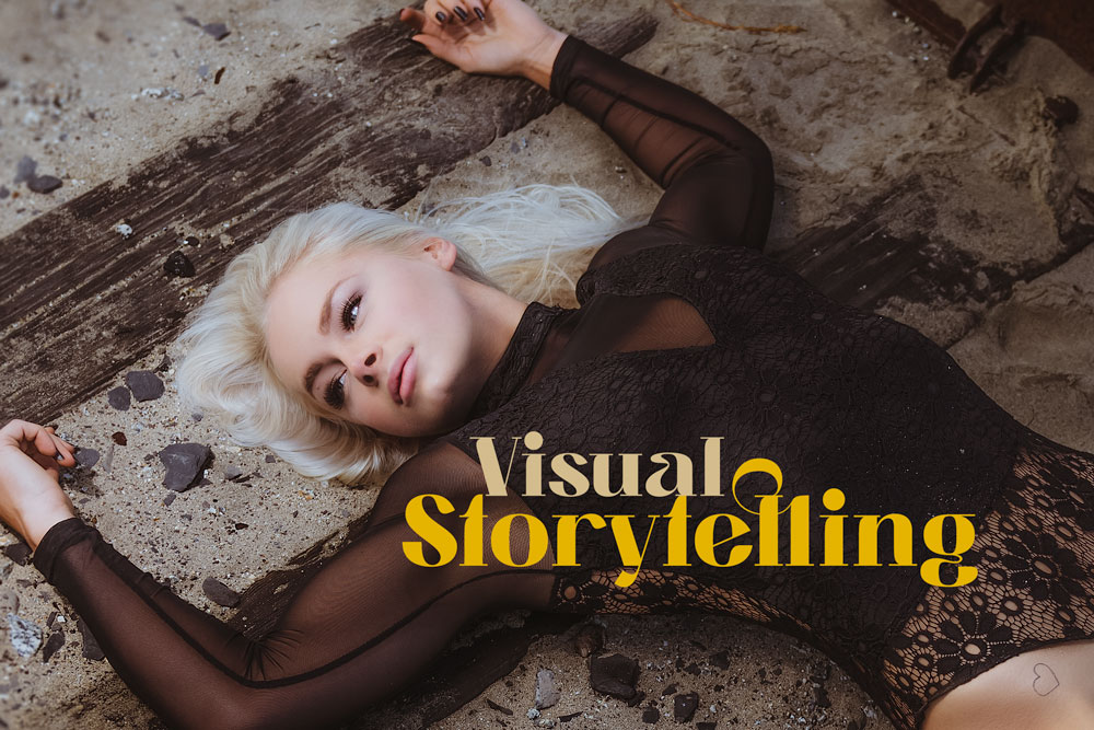 Fashion model in black lace outfit lying on a sandy surface with text "Visual Storytelling" - Visual Storytelling Techniques