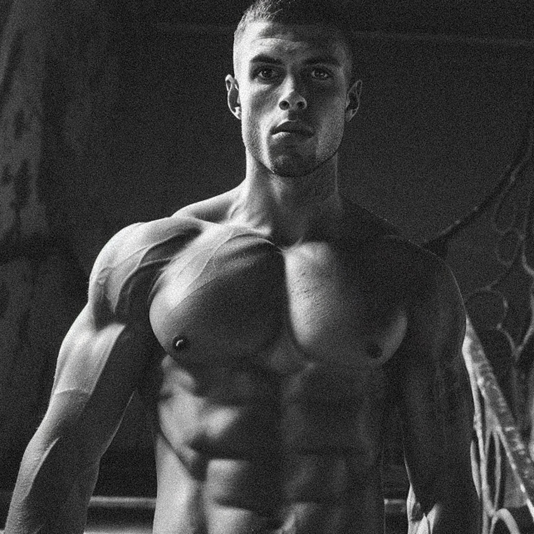 Powerful gaze body builder with chiseled abs in an abandoned house