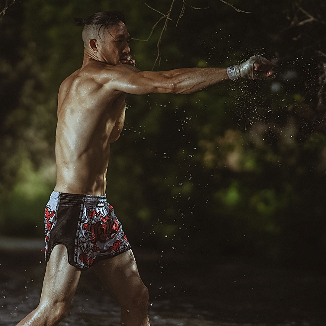 Muay thai fighter throwing punches in the river